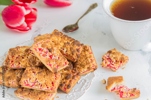 Fotografie, Obraz Homemade biscuits, grated pie with cherry jam,a Cup of tea, tulips