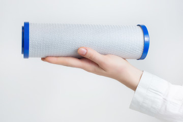 Poster - water filter cartridges in human hands 