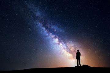 Wall Mural - milky way. night sky and silhouette of a standing man
