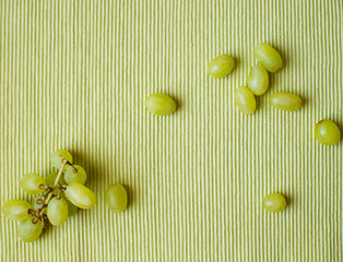 Green grapes on a green textured tablecloth