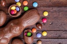 Chocolate Easter Eggs And Sweets On Wooden Background