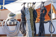 Colorful Nautical Accessories With Ropes, Pulley And Chromed Winch On A Well Equipment Wooden Sailboat