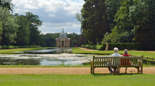  People On Bench Admiring The View Of The Thomas Archer Pavilion At Wrest Park.