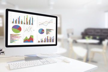 Poster - Modern computer with keyboard and mouse on table showing charts