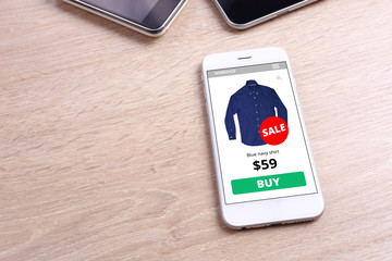 smartphone with shirt ecommerce website screen