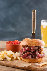 Canvas Print - Tasty steak burger on a wooden board