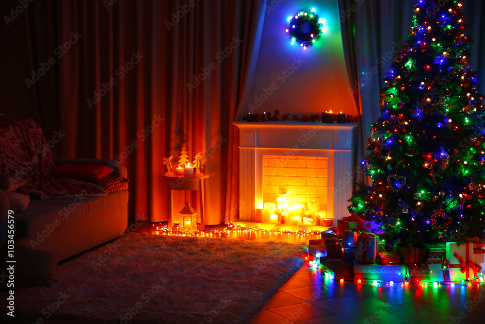 Christmas tree near fireplace and other decor in the room