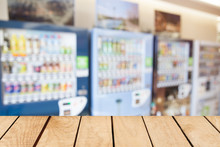 Empty Top Wooden Table And Blurred Image Of Vending Machine