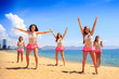© SlavaStock - cheerleaders dance differently on beach against azure sea