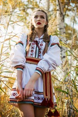 Young girl on the summer field  in national Belarus clothes, fas