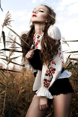 Young girl on the summer field  in national Belarus clothes, fas