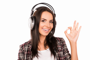 Wall Mural - Portrait of young smiling girl with head-phones listening music