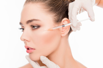 Close up portrait of young  woman getting cosmetic injection wit