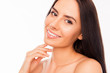 © deagreez - Beautiful young woman with big brown eyes touching her chin