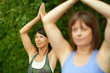 © AYAimages - Two mature women keeping fit by doing yoga in the summer