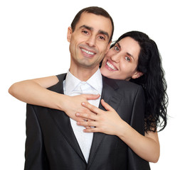 Wall Mural - Couple embrace, studio portrait on white. Dressed in black suit.