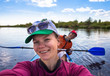 © lkoimages - Young woman doing selfie on kayak in beautiful nature. Summer sunny day