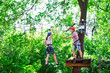 © davit85 - adventure climbing high wire park - people on course in mountain