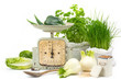 healthy cooking - vintage kitchen scales with fresh herbs and vegetables