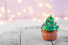 Christmas Cupcake With Sparkler And Lights On Background