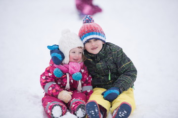 children group  having fun and play together in fresh snow