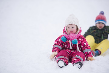 children group  having fun and play together in fresh snow