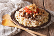 Arabic cuisine: kushari of rice, pasta, chickpeas and lentils close up 
