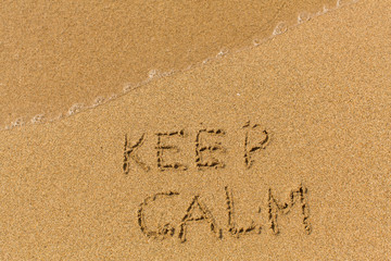 Wall Mural - Keep calm - text written on sandy beach with the soft wave.