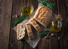 Sliced Italian Bread Ciabatta With Rosemary On Wooden Background
