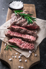 Wall Mural - Grilled beef steak with rosemary and salt on cutting board