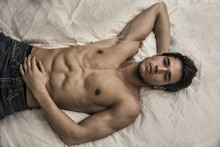 Shirtless Sexy Male Model Lying Alone On His Bed