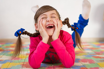 Cute little girl with pigtails is laughing