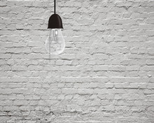 Hanging Light Bulb With Bricks Wall
