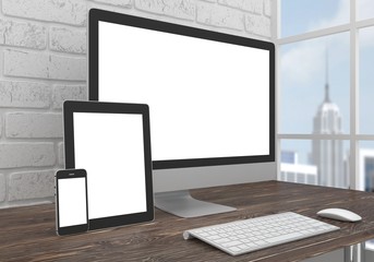 Wall Mural - Responsive mockup screen. Monitor, tablet, phone on table in office.