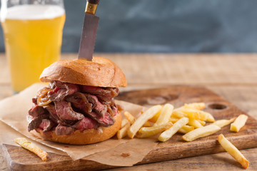 Canvas Print - Tasty steak burger on a wooden board