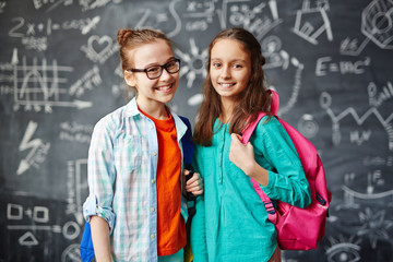 Poster - Adorable schoolmates with backpacks looking at camera