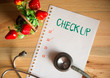 Health Check up list concept, top view of paper check list and Stethoscope on wood table , digital effect vintage style