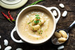 Creamy white bean soup on wooden background