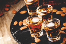Brandy And Almonds, Small Glasses On A Dark Background, Selectiv