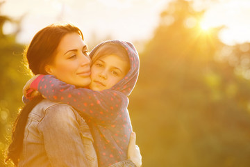 Wall Mural - Happy mother hugging daughter