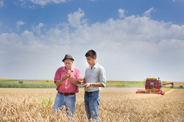 Canvas Print - Peasant and businessman at harvest