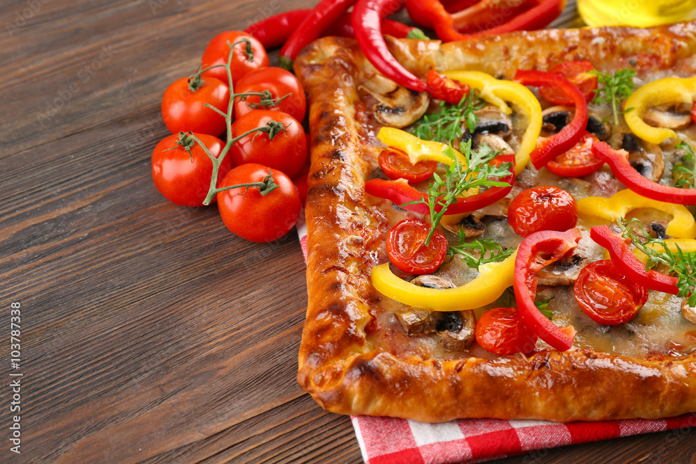 Freshly homemade pizza on wooden background