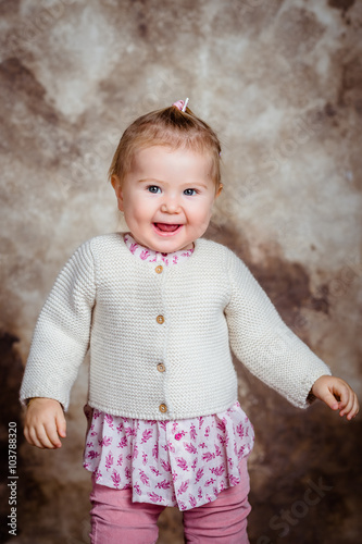 Cute Little Girl With Blond Hair And Grey Eyes Laughs And Dances