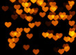 Many orange hearts on black background