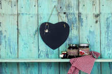 Slate Heart Hanging On Antique Rustic Teal Blue Background With Jars Of Fruit Jelly On Gingham Linen