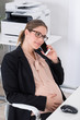 Pregnant Businesswoman Talking On Mobile Phone