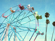 Aged And Worn Vintage Photo Of Ferris Wheel With Palm Trees.