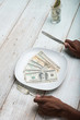  hand eating banknotes symbolising consumerism and corruption