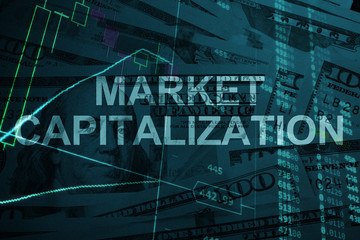 Words Market capitalization  with the financial data on the background. 