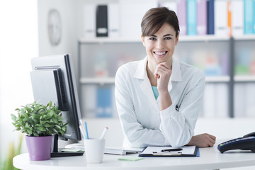 Wall Mural - Attractive doctor posing at the clinic reception